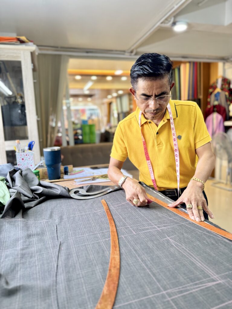The owner of a Hua Hin tailor shop is crafting a custom suit.